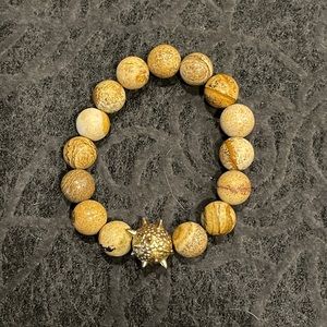 Sand stone stretch bracelet with gold spike ball accent